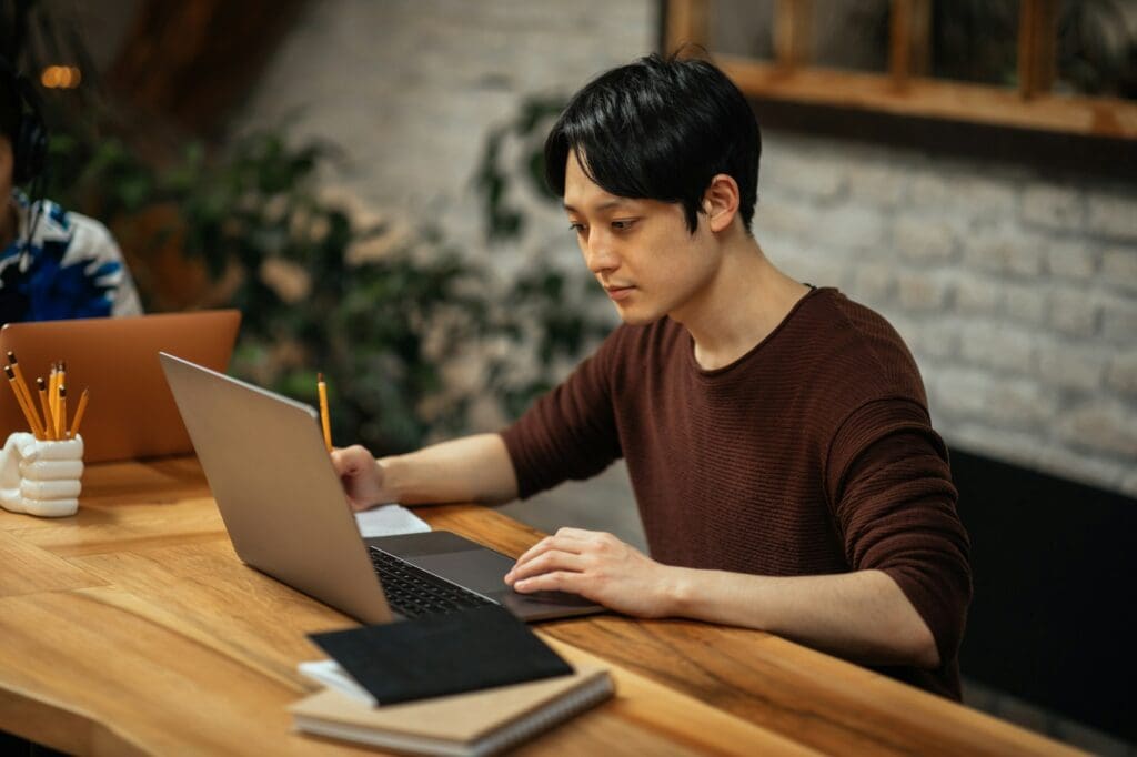 Japanese man working at home. typing on computer.