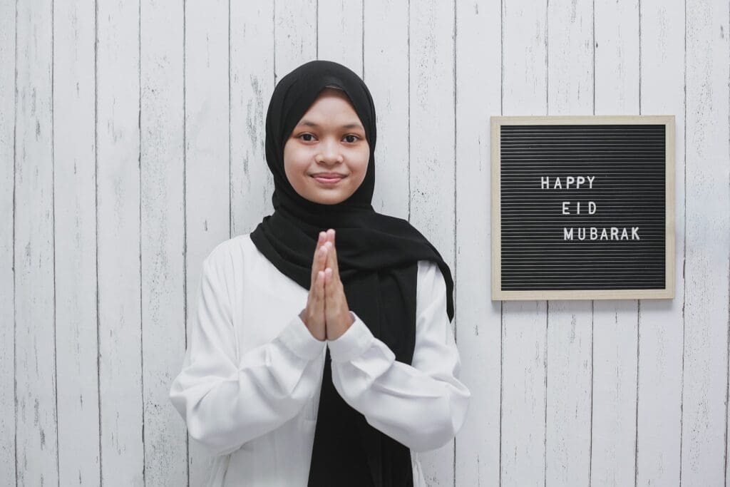 Young Muslim Woman With Greeting Pose on Eid Mubarak